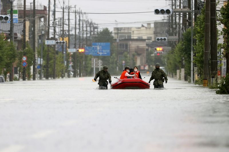 &copy; Reuters. Local residents are rescued by Japan Self-Defense Force soldiers after heavy rain in Omuta