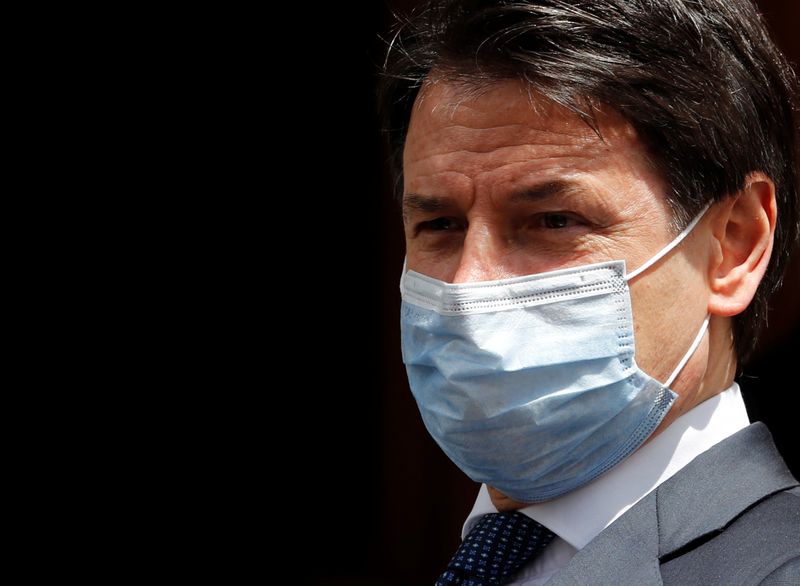 &copy; Reuters. Italian Prime Minister Giuseppe Conte wearing a protective face mask, leaves the Senate as the spread of the coronavirus disease (COVID-19) continues, in Rome