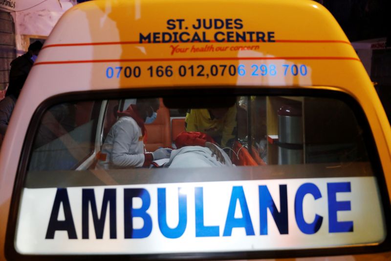 &copy; Reuters. Medics examine a pregnant woman in an ambulance during the coronavirus night curfew in Nairobi