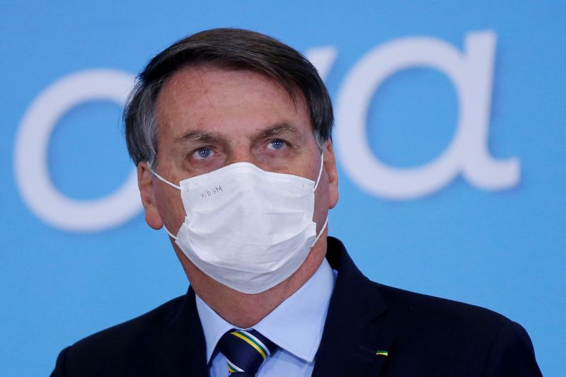 &copy; Reuters. FILE PHOTO: Brazil&apos;s President Jair Bolsonaro wearing a protective mask looks on during the launching ceremony of the Plano Safra 2020/2021, action plan for the agricultural sector, in Brasilia