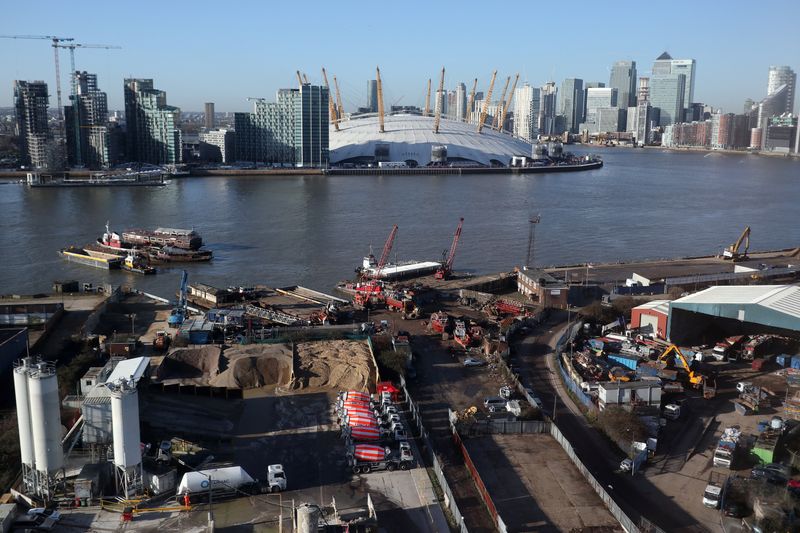 &copy; Reuters. FILE PHOTO: Construction work near the River Thames on the Greenwich Peninsula is seen next to the O2 and Canary Wharf financial district in London