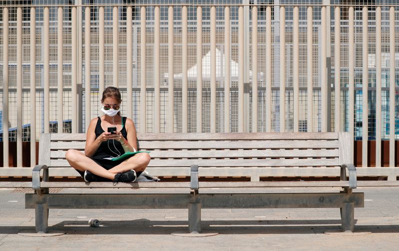 &copy; Reuters. Una mujer con mascarilla en Barcelona