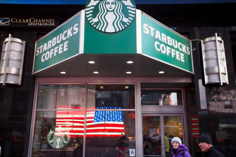 &copy; Reuters. Pedestrians walk past a Starbucks store in the Manhattan borough of New York