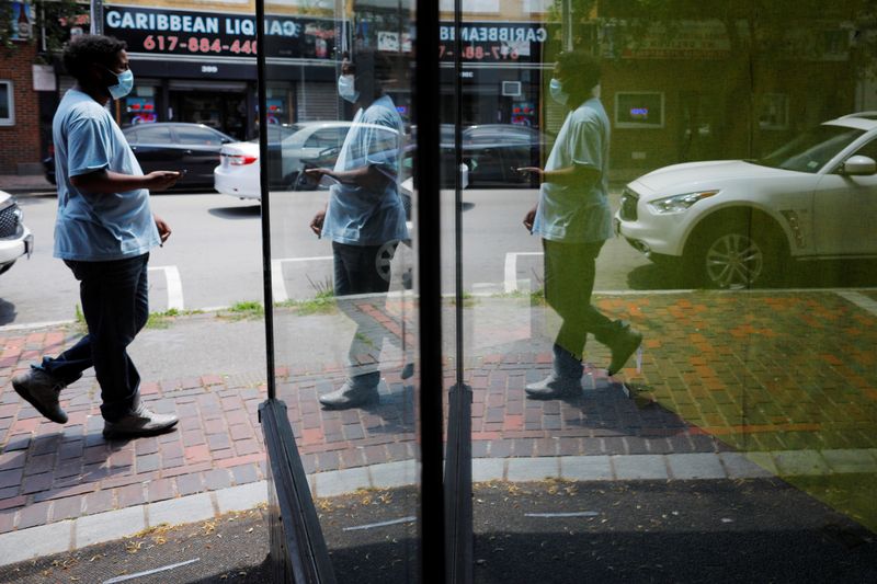 © Reuters. A pedestrian is reflected in the window of an empty storefront in Chelsea