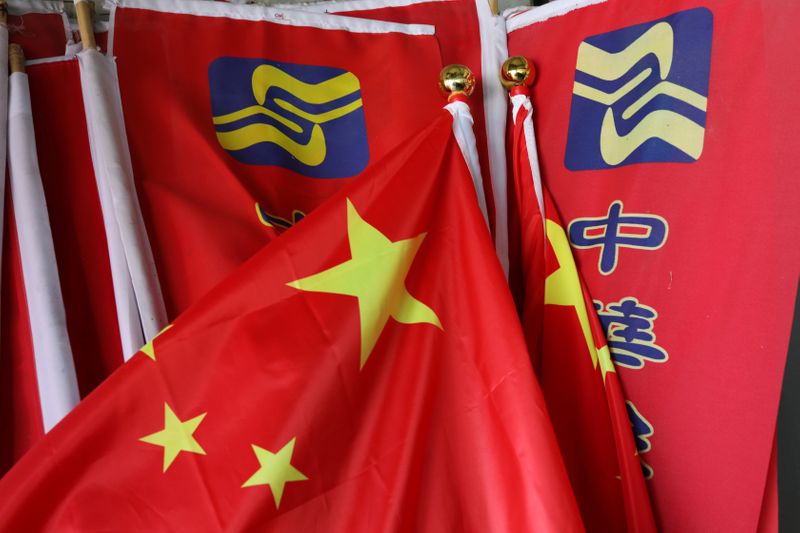 &copy; Reuters. FILE PHOTO: The party flag for the Chinese Unity Promotion Party and China&apos;s national flag are seen at Lin Guo-cingÕs office in Tainan