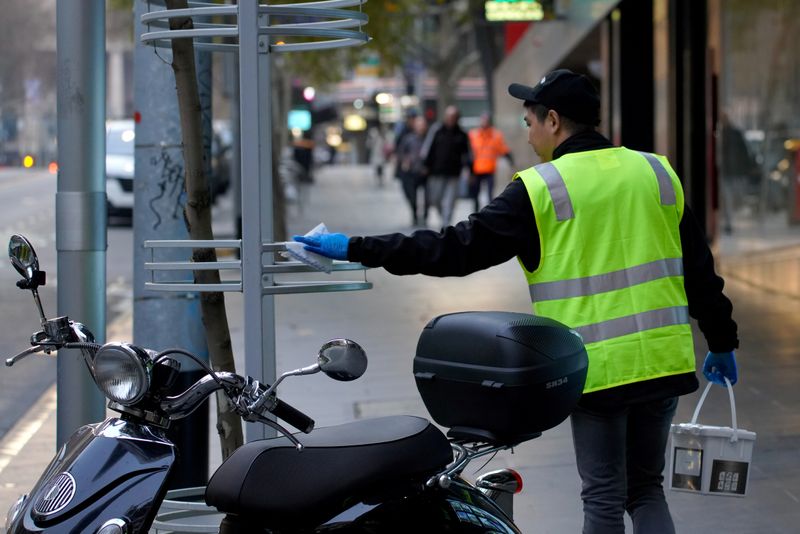&copy; Reuters. An essential worker sanitises surfaces under COVID-19 lockdown restrictions in Melbourne