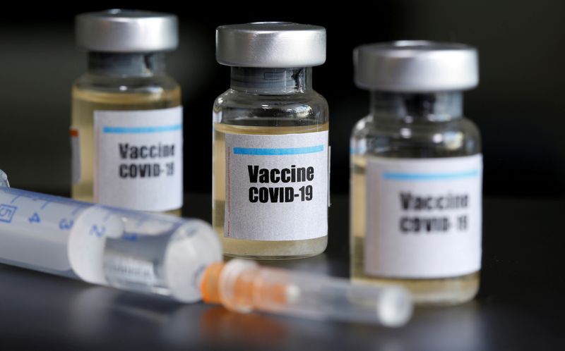 &copy; Reuters. Small bottles labeled with a &quot;Vaccine COVID-19&quot; sticker and a medical syringe are seen in this illustration