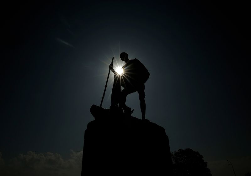 &copy; Reuters. A statue of Mahatma Gandhi is silhouetted during partial solar eclipse in Chennai