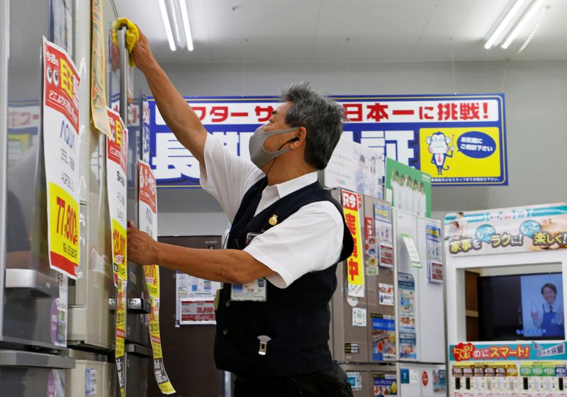&copy; Reuters. 74-year-old store clerk Tadashi Sato works at the electronics retailer Nojima&apos;s store in Fujisawa