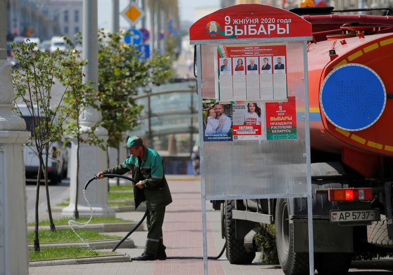 &copy; Reuters. FILE PHOTO: Municipal worker waters the grass near a poster reading &quot;August 9, 2020. Presidential Elections in Belarus&quot; in Minsk