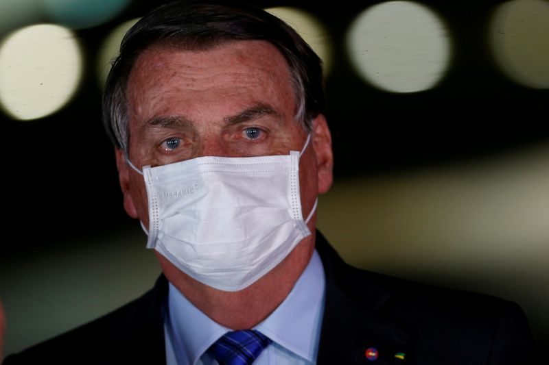 &copy; Reuters. FILE PHOTO: Brazil&apos;s President Jair Bolsonaro looks on during a press statement at the Alvorada Palace in Brasilia