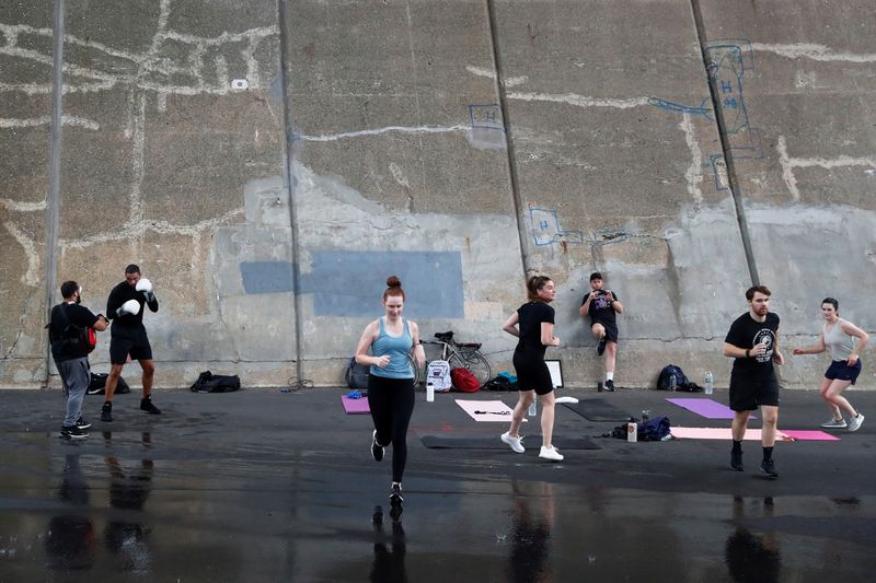 &copy; Reuters. People exercise under the Triborough Bridge in the Queens borough of New York