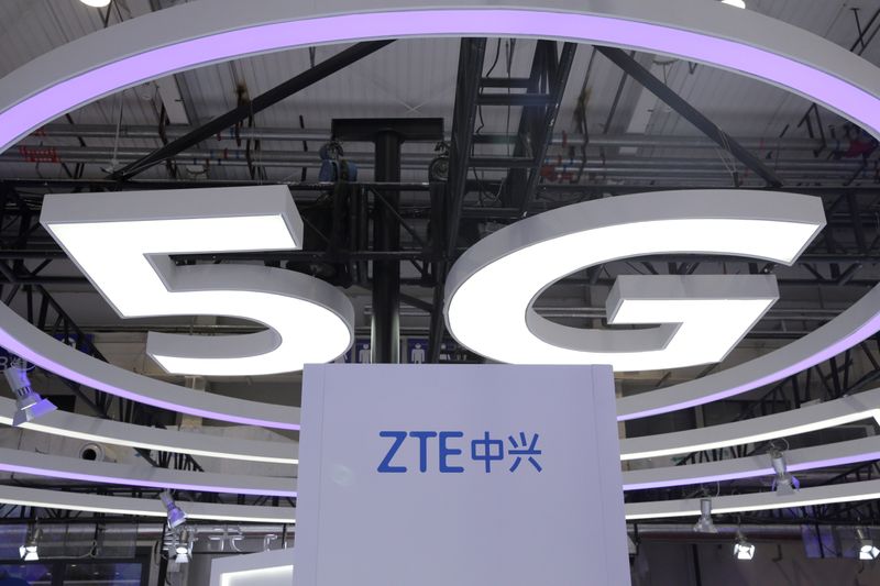 © Reuters. FILE PHOTO: The logo for ZTE, a popular pick among Korean investors, and a sign for 5G are seen at the World 5G Exhibition in Beijing