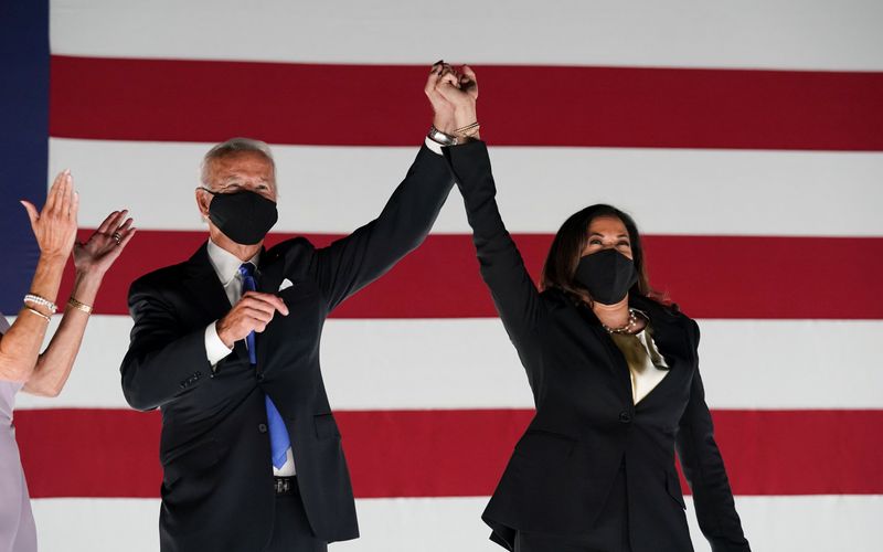 &copy; Reuters. Democratic presidential candidate Joe Biden and Kamala Harris celebrate in Wilmington, Delaware