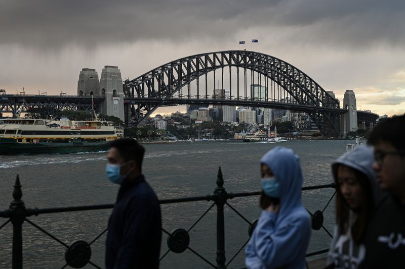 &copy; Reuters. People walk in front of the Sydney Harbour Bridge in Sydney