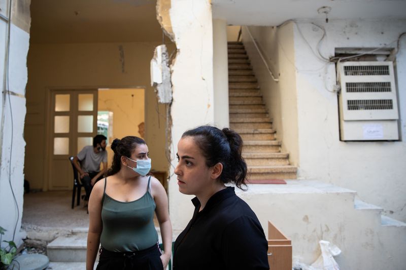 &copy; Reuters. Lourdes Fakhri and Sandra Abinader are seen at the yard of the damaged building they live in, in the aftermath of a massive explosion at the port area, in Beirut