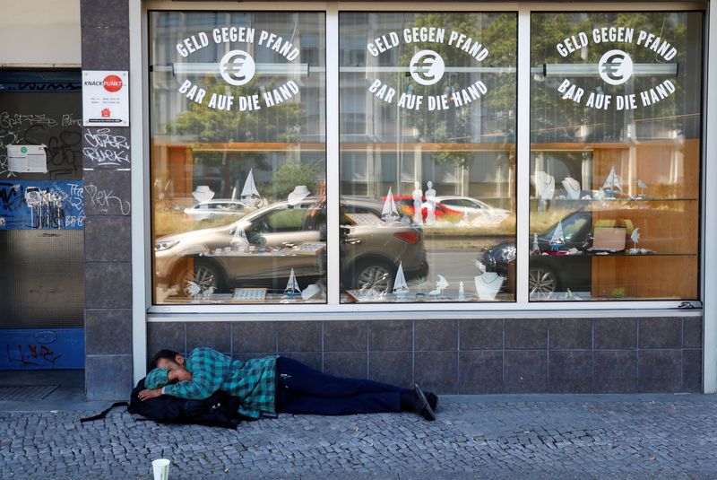 &copy; Reuters. Homeless man is pictured in front of a pawnshop in Berlin