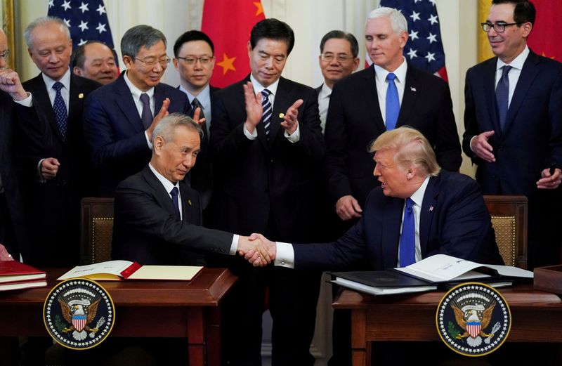 &copy; Reuters. FILE PHOTO: Chinese Vice Premier Liu He and U.S. President Donald Trump shake hands after signing &quot;phase one&quot; of the U.S.-China trade agreement at the White House in Washington