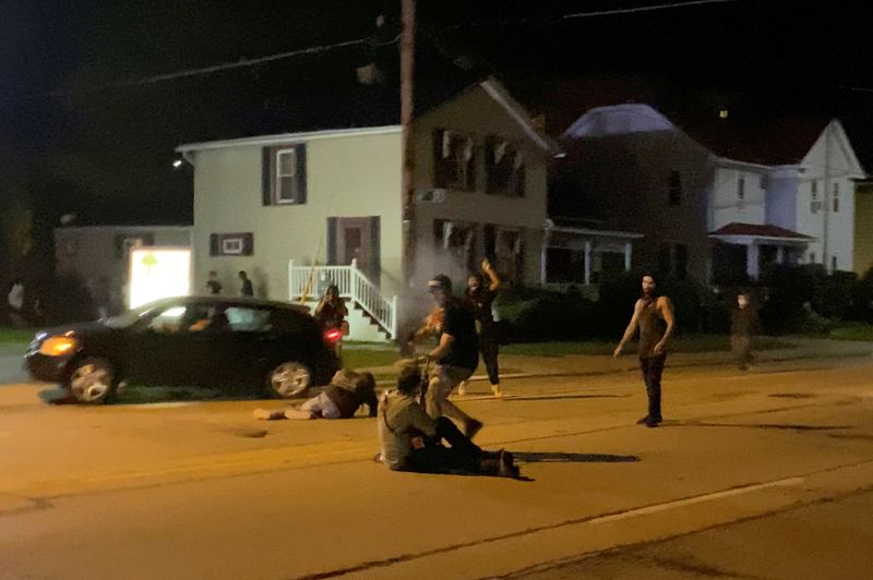 © Reuters. A man is being shot in his arm during a protest following the police shooting of Jacob Blake, a Black man, in Kenosha