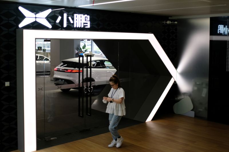 &copy; Reuters. Woman walks by an Xpeng Motors showroom at its headquarters in Guangzhou