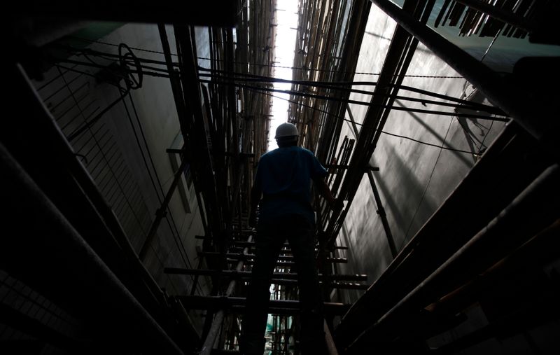 &copy; Reuters. A worker stands on scaffolds at a construction site in Shenzhen