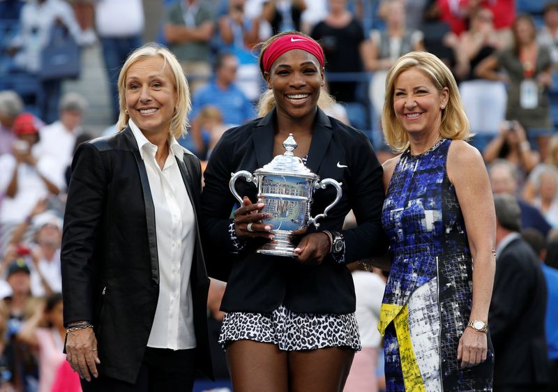 &copy; Reuters. FILE PHOTO: Williams of the U.S. holds her trophy while flanked by tennis greats Navratilova and Evert after Williams defeated Wozniacki of Denmark in their women&apos;s singles finals match at the 2014 U.S. Open tennis tournament in New York