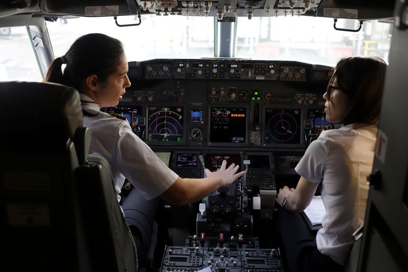 &copy; Reuters. FILE PHOTO: Captain Natalia Weiss and co-pilot Thays Goncalves of Brazilian Airline GOL prepare before taking off with a full female crew in the mark of International Women&apos;s Day, in Sao Paulo