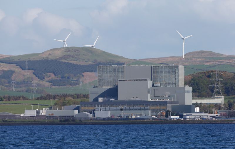 &copy; Reuters. Wind turbines are seen behind Hunterston B Nuclear Power Station in West Kilbride, Scotland