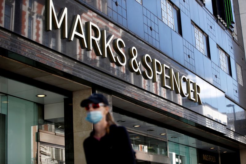 &copy; Reuters. FILE PHOTO: A woman walks past a M&amp;S store at Oxford Street in London, Britain