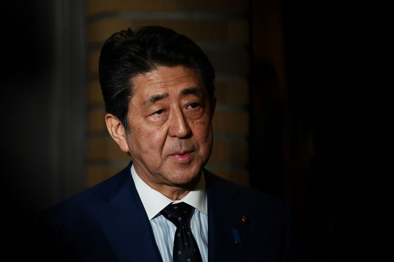 © Reuters. Japan's Prime Minister Shinzo Abe talks to the journalists in front of the prime minister's residence in Tokyo