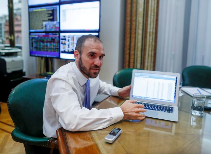 &copy; Reuters. FILE PHOTO: Argentine Economy Minister Martin Guzman shows a graphic during an interview with Reuters, in Buenos Aires