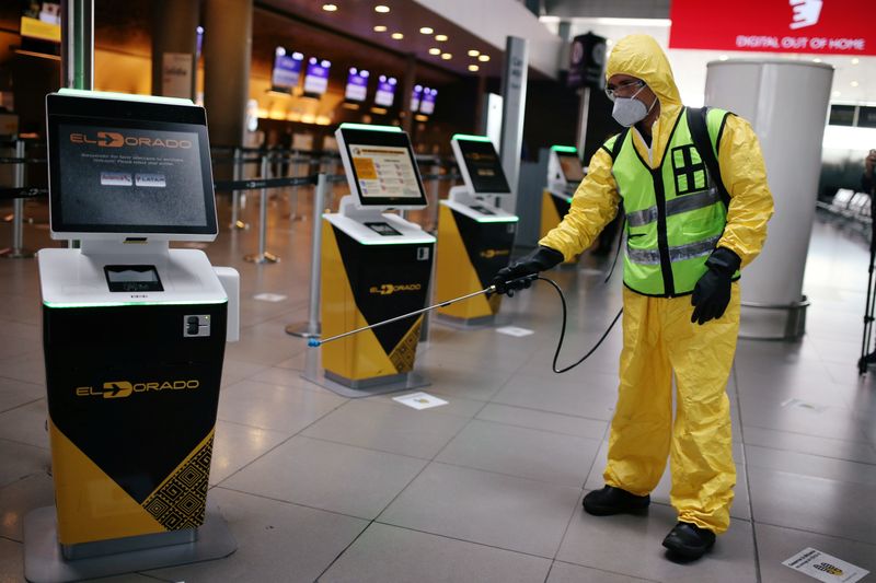 &copy; Reuters. A man wearing protective gear disinfects a facility of the El Dorado International Airport, amidst the coronavirus disease (COVID-19) outbreak, in Bogota