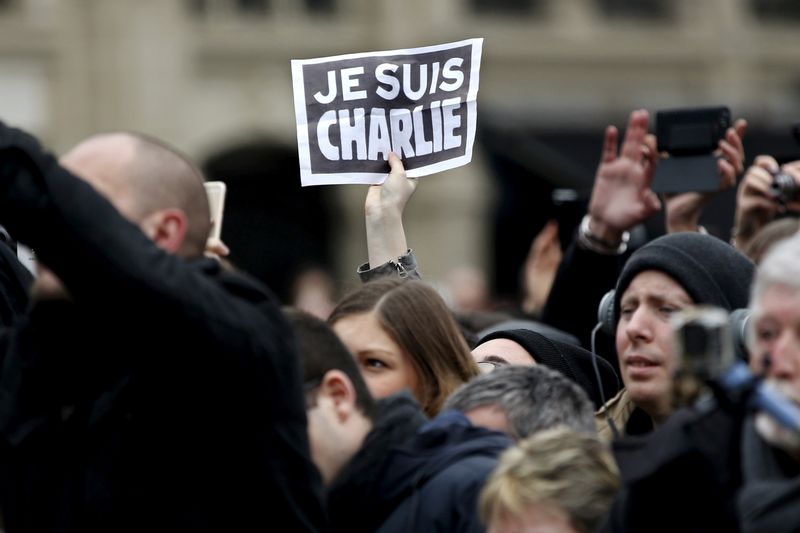 &copy; Reuters. FILE PHOTO: Person holds up a sign during a ceremony at Place de la Republique square to pay tribute to the victims of last year&apos;s shooting at the French satirical newspaper Charlie Hebdo, in Paris