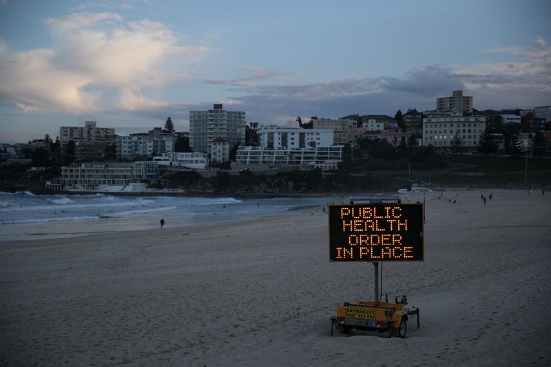 © Reuters. FILE PHOTO: A public health message is seen at Bondi Beach in Sydney