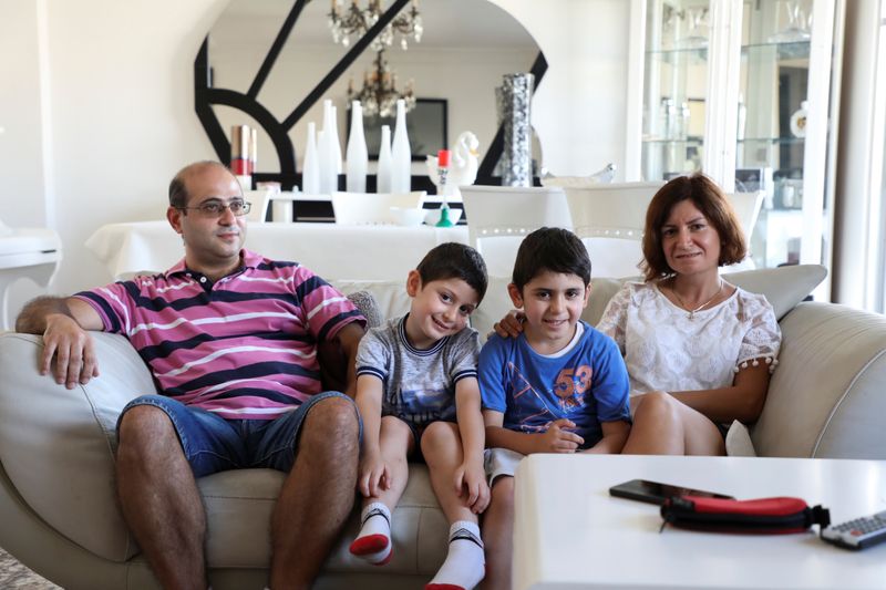 &copy; Reuters. Nadim Srour, a 43-year-old who returned from the Gulf, is pictured with his wife and sons in Beirut