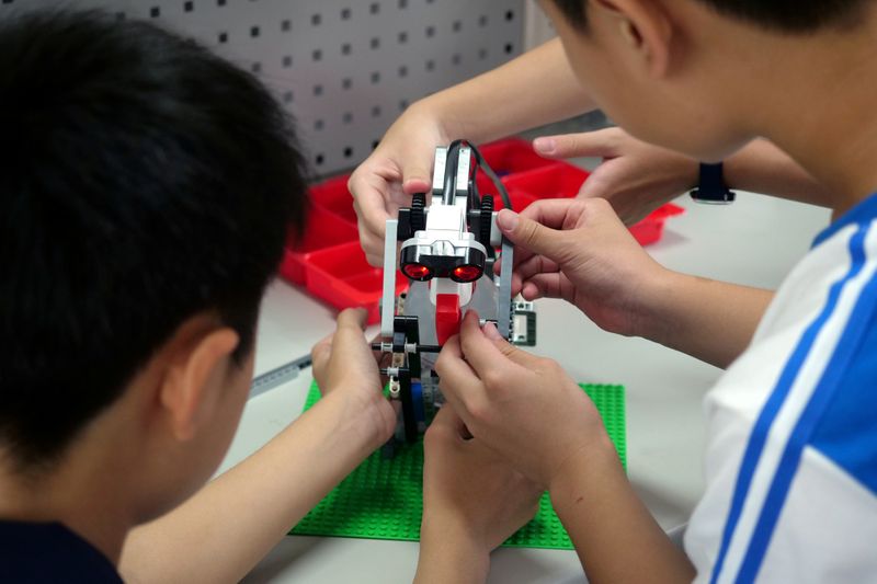 &copy; Reuters. FILE PHOTO: Elementary school students build a motion sensor controlled disinfectant dispenser from Lego parts during a workshop, following a novel coronavirus outbreak, in the southern Taiwanese city of Kaohsiung