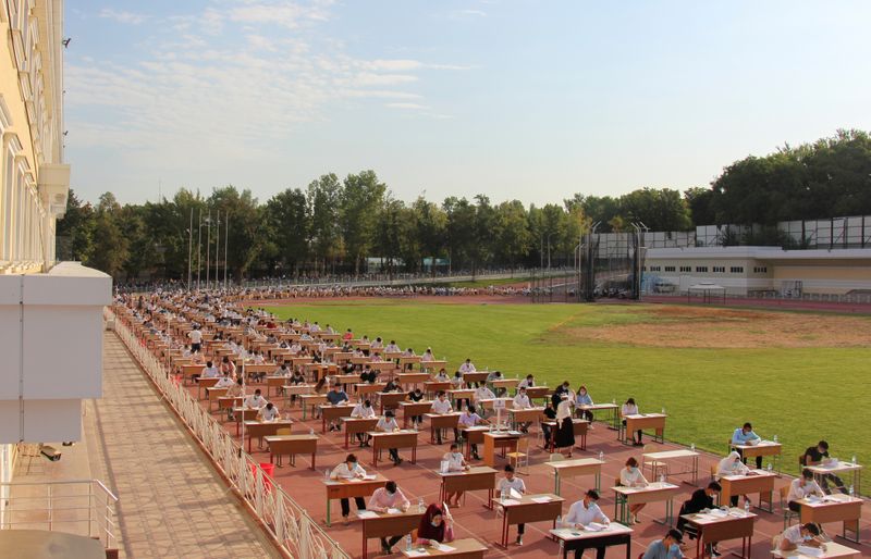 &copy; Reuters. School graduates take university entrance exams at a sports arena amid the outbreak of the coronavirus disease in Tashkent