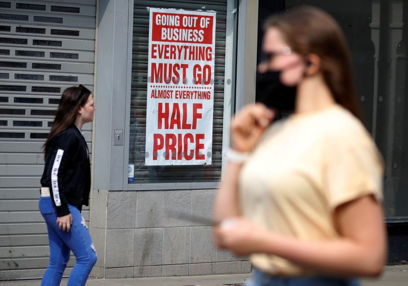 &copy; Reuters. FILE PHOTO: People walk past a closed shop following the outbreak of the coronavirus disease (COVID-19) in Chester, Britain