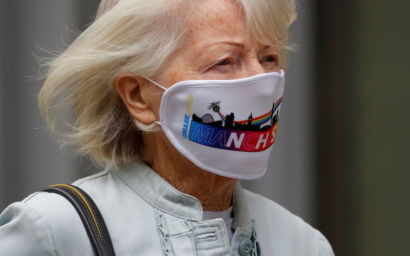 &copy; Reuters. A woman wears a &apos;Manchester&apos; themed face mask as she walks in the city centre in Manchester, Britain