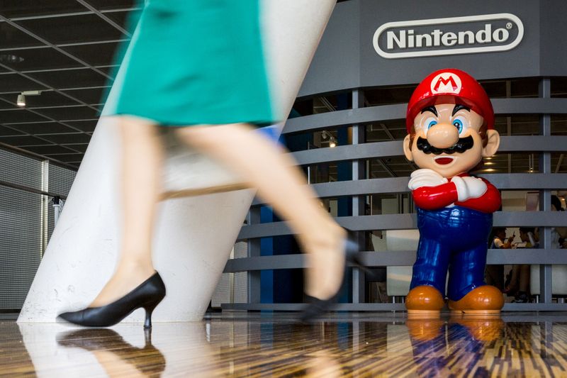 &copy; Reuters. FILE PHOTO: Woman walks past figure of &quot;Mario&quot; video game character at Nintendo centre in Tokyo, Japan