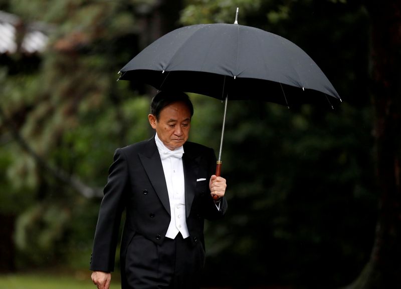 &copy; Reuters. FILE PHOTO: Japan&apos;s Chief Cabinet Secretary Yoshihide Suga arrives at the ceremony site where Emperor Naruhito will report the conduct of the enthronement ceremony at the Imperial Sanctuary inside the Imperial Palace in Tokyo