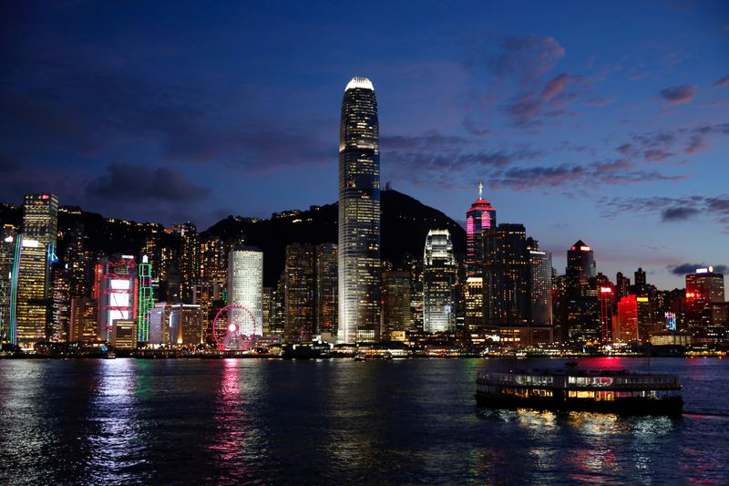 &copy; Reuters. FILE PHOTO: A Star Ferry boat crosses Victoria Harbour in front of a skyline of buildings during sunset.