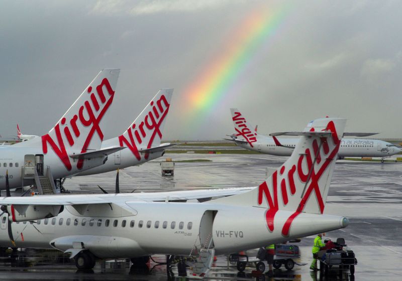 &copy; Reuters. FILE PHOTO: A rainbow from a passing rain shower sits over Virgin Australia aircraft at Sydney&apos;s Airport in Australia