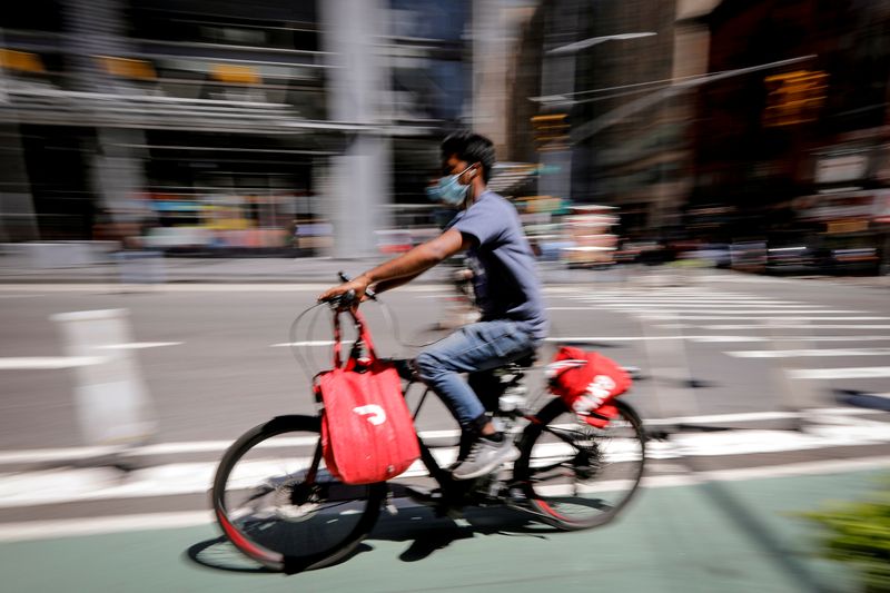 &copy; Reuters. FILE PHOTO: A rider for &quot;Grubhub&quot; food delivery service rides a bicycle during a delivery in midtown Manhattan in New York