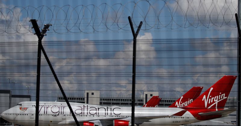 &copy; Reuters. FILE PHOTO: Grounded Virgin Atlantic aircraft are seen through the fences as they remain grounded at Manchester Airport