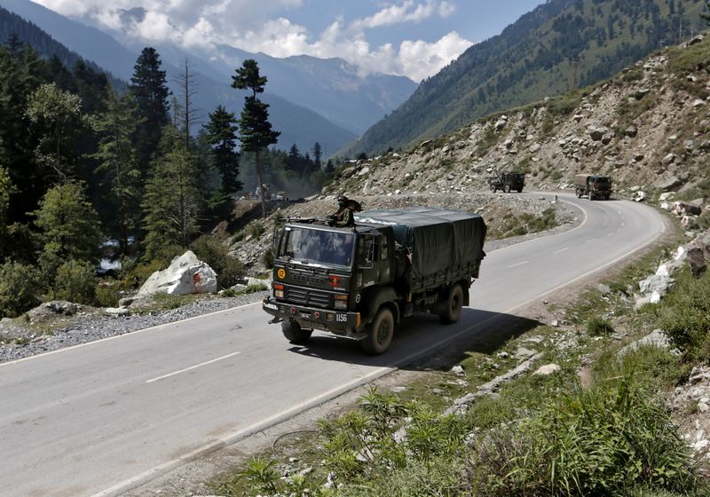 &copy; Reuters. Indian army trucks move along a highway leading to Ladakh, at Gagangeer