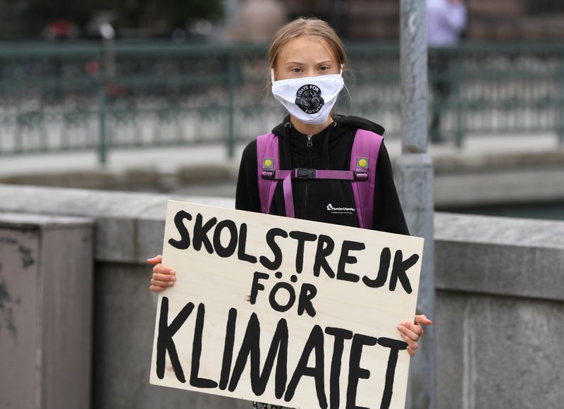 &copy; Reuters. Swedish climate activist Greta Thunberg holds a poster reading &quot;School strike for Climate&quot;, in Stockholm