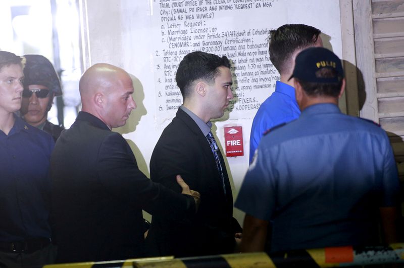&copy; Reuters. U.S. Marine Lance Corporal Joseph Scott Pemberton is escorted by U.S. security into a court in Olongapo city, north of Manila