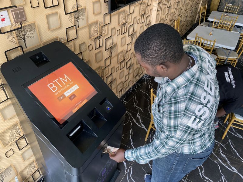 &copy; Reuters. A bitcoin user buys bitcoins with naira on Bitcoin Teller Machine in Lagos