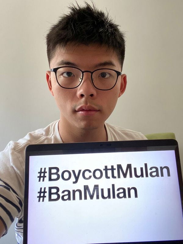 &copy; Reuters. Joshua Wong holds a monitor with hashtags BoycottMulan and BanMulan written on it, in Hong Kong